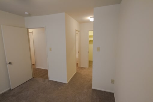 This is a photo looking towards the primary bathroom and walk-in closet in the primary bedroom in a 849 square foot 2 bedroom, 2 bath apartment at Park Lane Apartments in Cincinnati, OH.