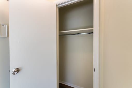 A white door with a silver handle is open.