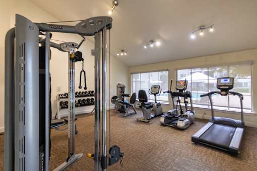 The 24-hour fitness center with treadmill, elliptical, free weights and other workout machines at The Summit at Midtown Apartments in Midtown, Dallas, TX.