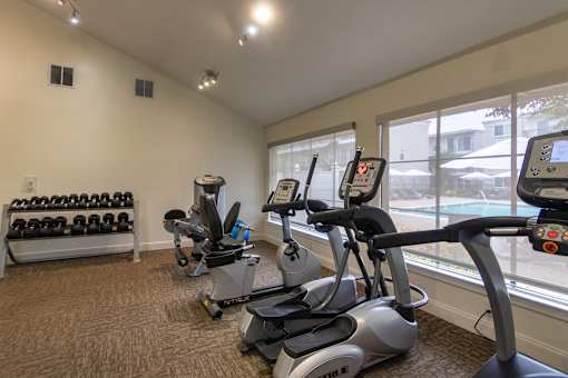 The 24-hour fitness center with treadmill, elliptical, free weights and other workout machines at The Summit at Midtown Apartments in Midtown, Dallas, TX.