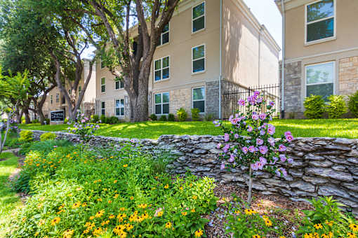 Building exteriors and landscaping at The Summit at Midtown Apartments in Midtown, Dallas, TX.