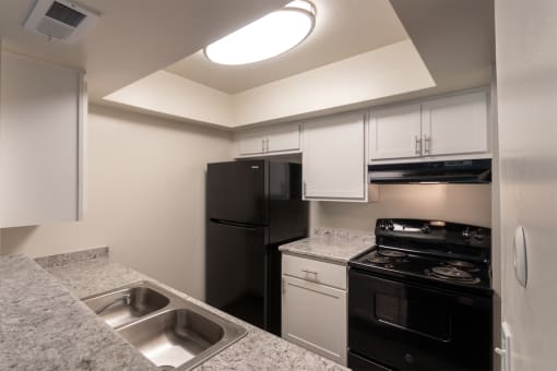 Kitchen With Black Appliances at Village East, Franklin, OH