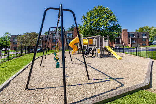 Swing set and playground area with safety surface at Village East Apartments in Franklin, Ohio