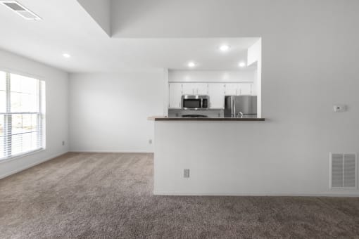 This is a photo of the dining room and kitchen of the 1100 square foot 2 bedroom, 2 bath Eaton floor plan at Washington Park Apartments in Centerville, OH.