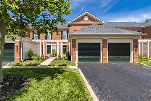 A house with a green garage door in front.