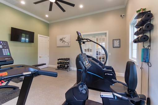The 24-hour fitness center with treadmill, cycling machine, stair stepper, yoga mats and free weights at Washington Park Apartments, in Centerville, OH.