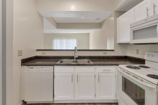 This is a photo of the kitchen of the 1280 square foot 2 bedroom, 2 and 1/2 bath Oakwood floor plan at Washington Park Apartments in Centerville, OH.
