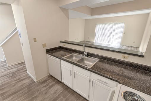 This is a photo of the kitchen of the 1280 square foot 2 bedroom, 2 and 1/2 bath Oakwood floor plan at Washington Park Apartments in Centerville, OH.