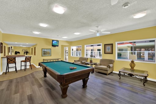 a game room with a pool table    and a bar at Olive Tree Apartments, Torrance, CA