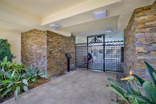 the entrance to a building with a gate at Olive Tree Apartments, California