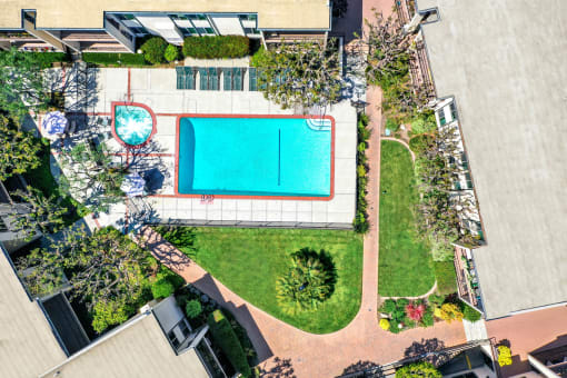 an aerial view of a pool and a yard with a tennis court at Casa Del Amo Apartments, California, 90505