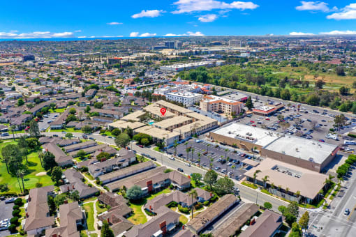 an aerial view of a city with a parking lot and buildings at Casa Del Amo Apartments, California