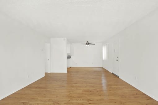 an empty living room with white walls and a ceiling fan at Casa Del Amo Apartments, California, 90505