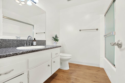 a bathroom with a sink and a toilet and a shower at Casa Del Amo Apartments, Torrance