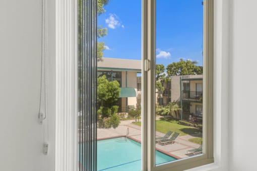 a view of the pool from a window at Copa Ladeene Apartments, Torrance California
