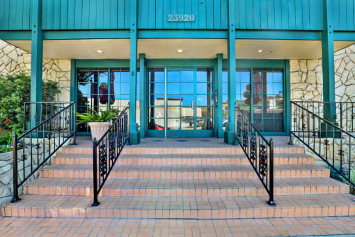 the entrance to a building with stairs and railings at Copa Ladeene Apartments, Torrance California