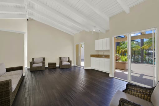 a living room with wooden floors and a door to a balcony at Copa Triana Apartments, Torrance