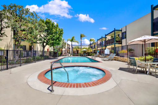our apartments have a hot tub and a pool with tables and chairs at Copa Triana Apartments, Torrance