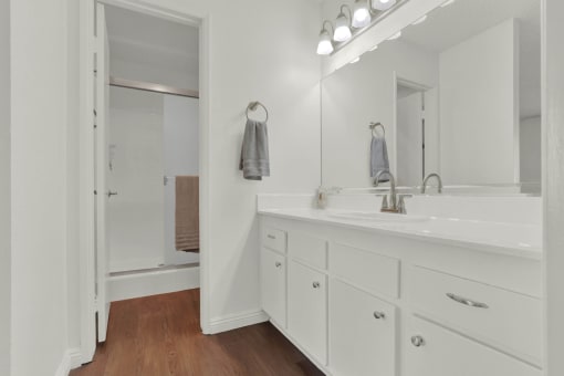 a bathroom with a sink and a mirror at Copa Triana Apartments, Torrance