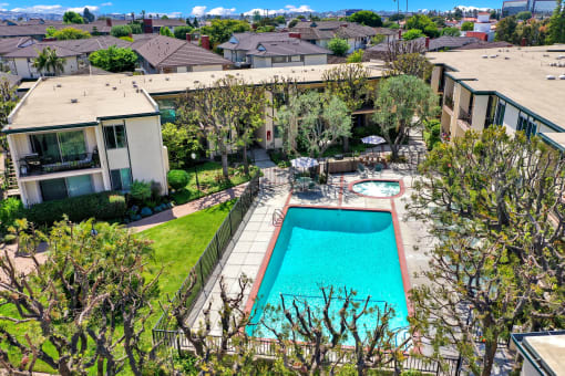 a backyard with a swimming pool and a house at Casa Del Amo Apartments, Torrance, CA 90505