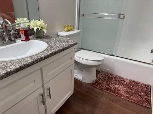 A bathroom with a sink, toilet, and shower.  at Casa De Oro Apartments, Torrance, 90505