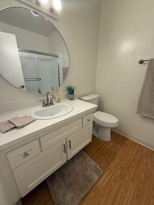 A bathroom with a white sink and toilet.