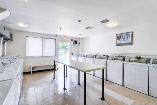 a kitchen with a table and counters and a sink