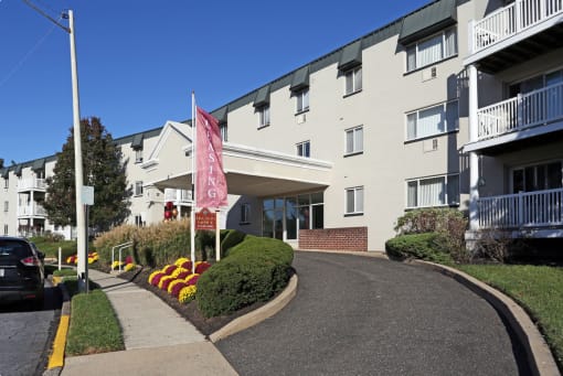 an apartment building with a pink flag in front of it
