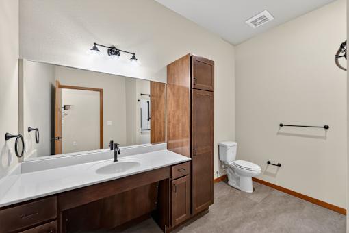 A bathroom with a white sink and a white toilet.