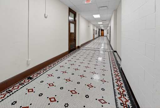 A long hallway with a tiled floor and white walls.