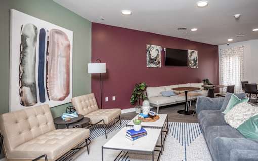 A living room with a grey couch, a white chair, and a coffee table.