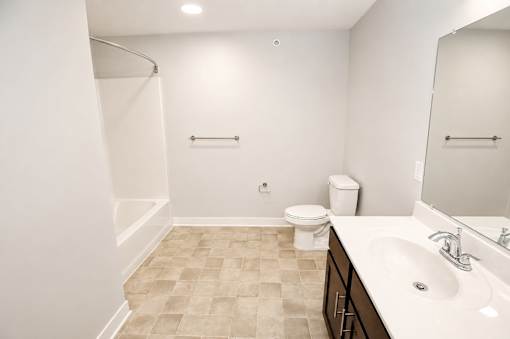 A bathroom with a toilet, sink, and shower.