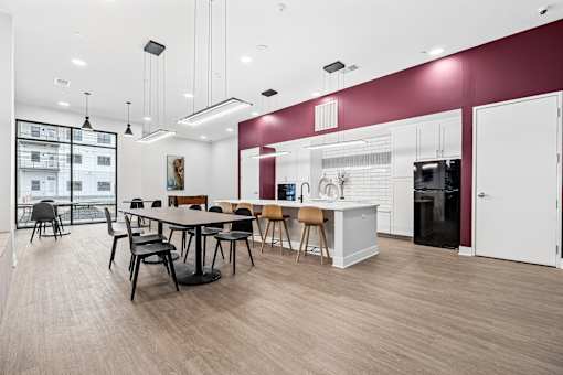 A modern kitchen with a dining table and chairs.