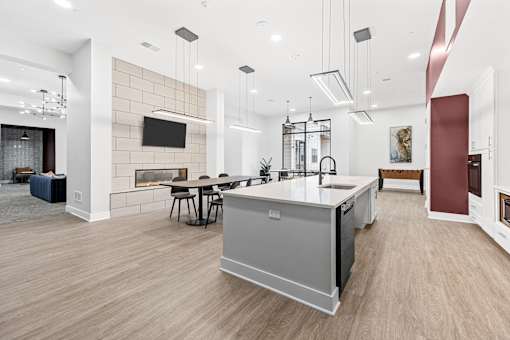 A modern kitchen with a large island and a fireplace.