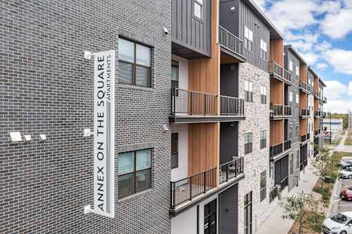 Apartment building with a sign that says Annex on the Square.