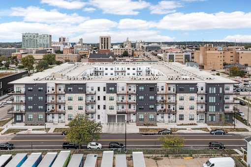 A large building with a parking lot in front of it.