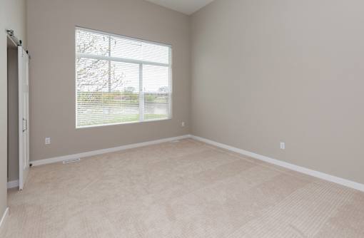 A room with a large window and a sliding door.at 5Fifty5, Des Moines, 50309  