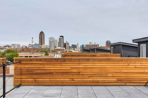 a wooden wall on a roof with a city skyline in the background at 5Fifty5, Iowa  