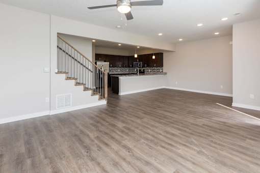 an empty living room and kitchen with wood flooring at 5Fifty5, Des Moines, 50309  