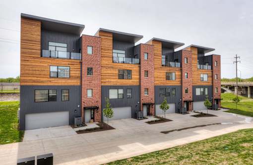 modern apartment buildings with a sidewalk and grass at 5Fifty5, Des Moines, 50309  