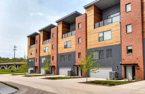 a row of new apartment buildings with a road in front of them at 5Fifty5, Des Moines  