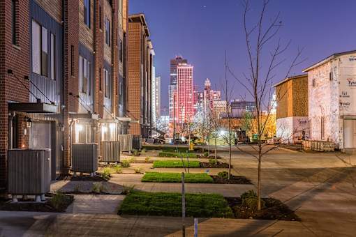 a view of the city skyline at night from a street at 5Fifty5, Iowa  