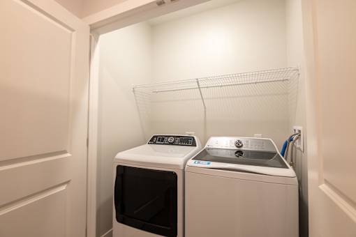 A small laundry room with a washer and dryer.