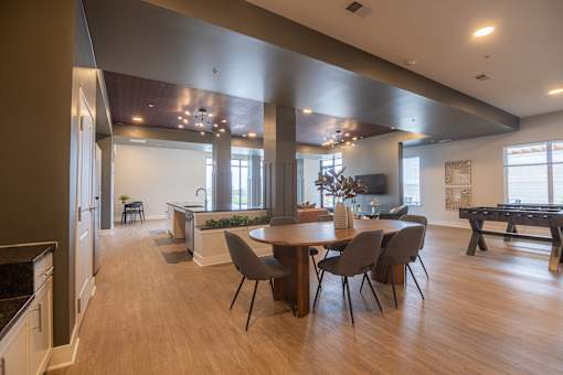 A modern kitchen with a dining table and chairs.