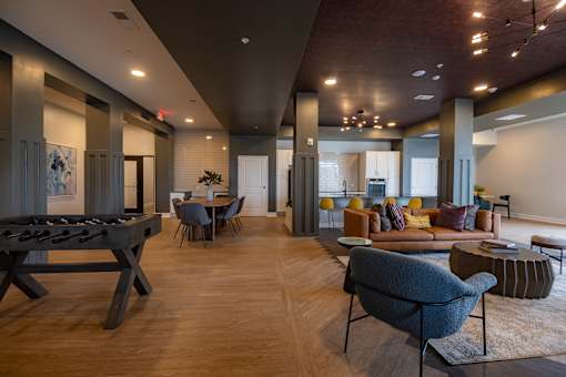 A modern living room with a pool table and comfortable seating.