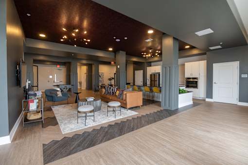 A modern living room with a wooden floor and a grey wall.