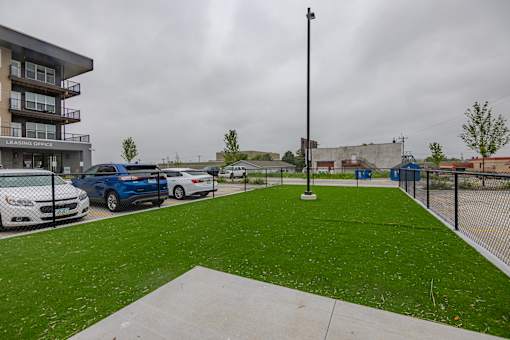 A leasing office is located in a building next to a parking lot with cars parked in it.