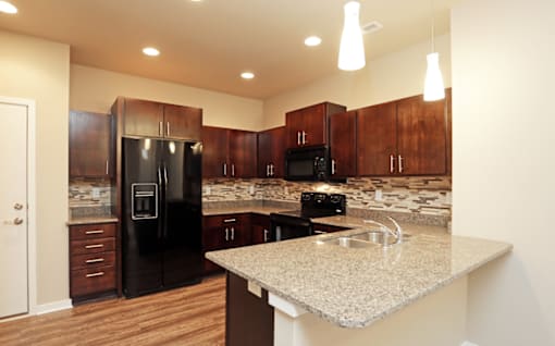 Fully Equipped Kitchen With Modern Appliances at 7th Street Brownstones, Indigo Living, IA, 50309