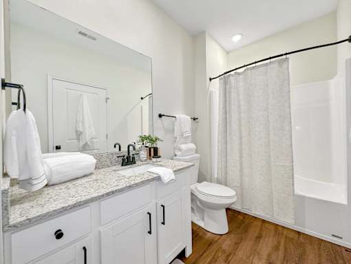 a bathroom with a shower and a toilet and a sink at 92West, Iowa, 50266