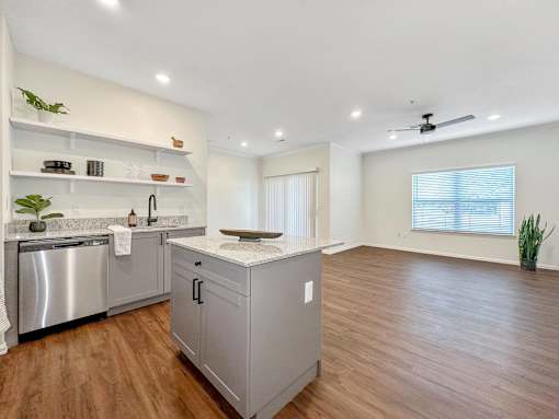 a kitchen with a counter top and a stainless steel refrigerator at 92West, West Des Moines, Iowa
